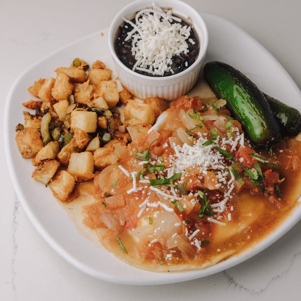 Braxton's Kitchen huevos rancheros with black beans, home fries, and two roasted jalapeños.
